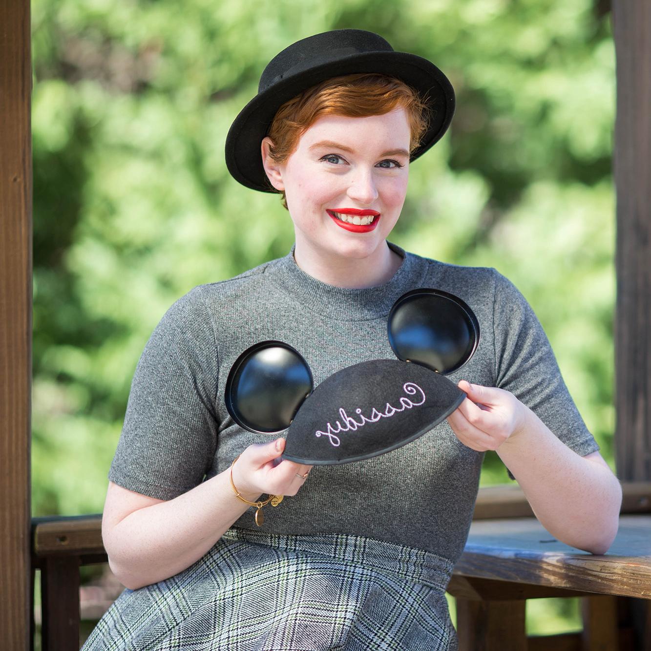 Cassidy with a disney cap in her h和